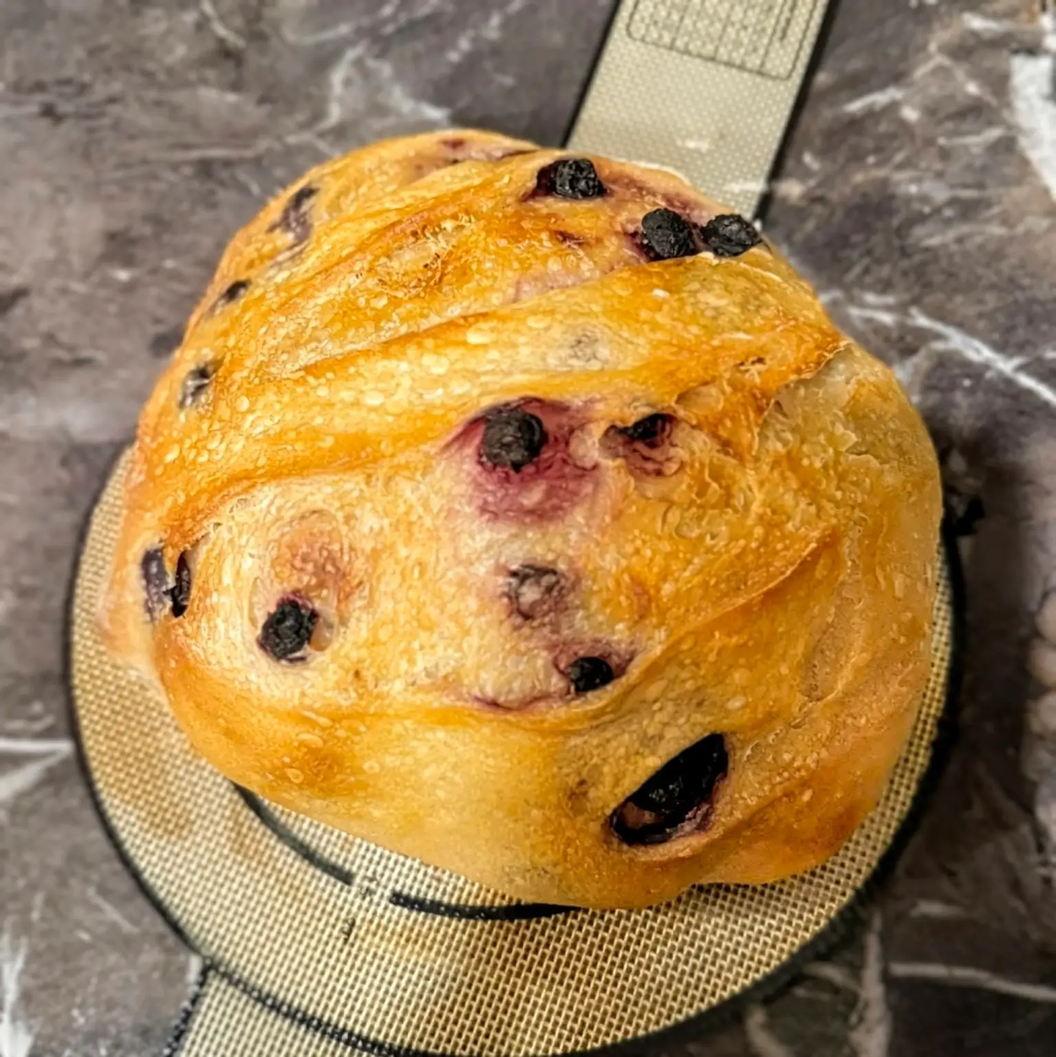 A loaf of artisanal sourdough bread with a perfect crust